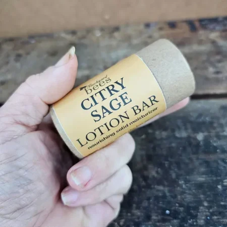 Citry Sage Lotion Bar held in hand to show size of the eco-friendly paper tube
