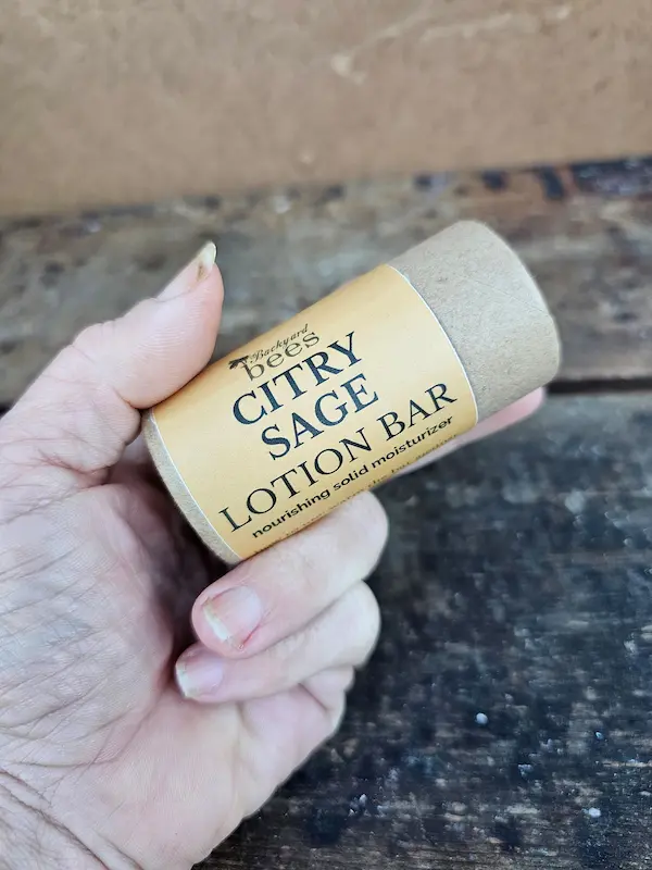 Citry Sage Lotion Bar held in hand to show size of the eco-friendly paper tube