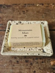 Mountain Man soap for men with earthy woods soap on ceramic dish