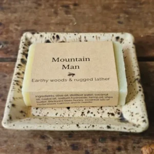 Mountain Man soap for men with earthy woods soap on ceramic dish