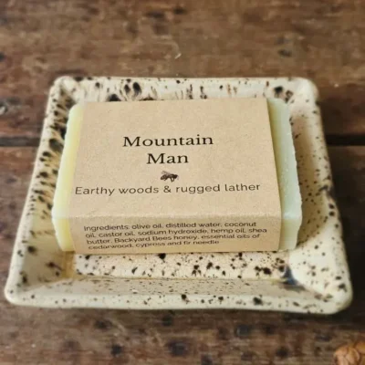 Mountain Man soap for men with earthy woods soap on ceramic dish