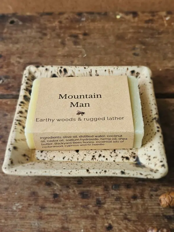Mountain Man soap for men with earthy woods soap on ceramic dish