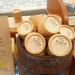 tabletop wooden barrel full of beard balms