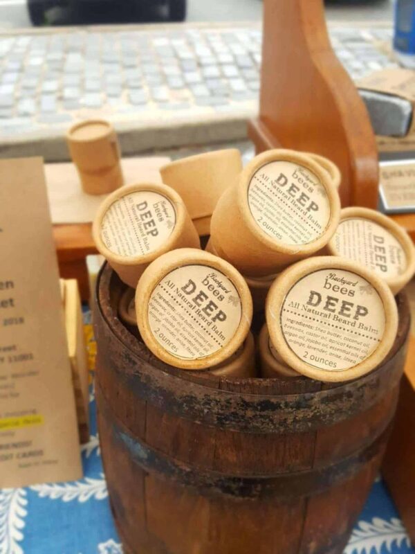 tabletop wooden barrel full of beard balms