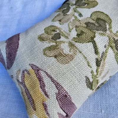 Close-up texture of salvaged floral linen fabric used for Backyard Bees lavender eye pillow cover.