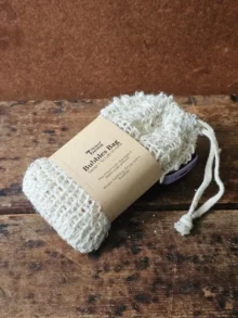 closeup of the Backyard Bees bubble bag, a reusable sisal soap saver bag prefilled with soap shreds