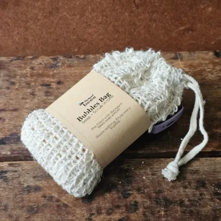 closeup of the Backyard Bees bubble bag, a reusable sisal soap saver bag prefilled with soap shreds