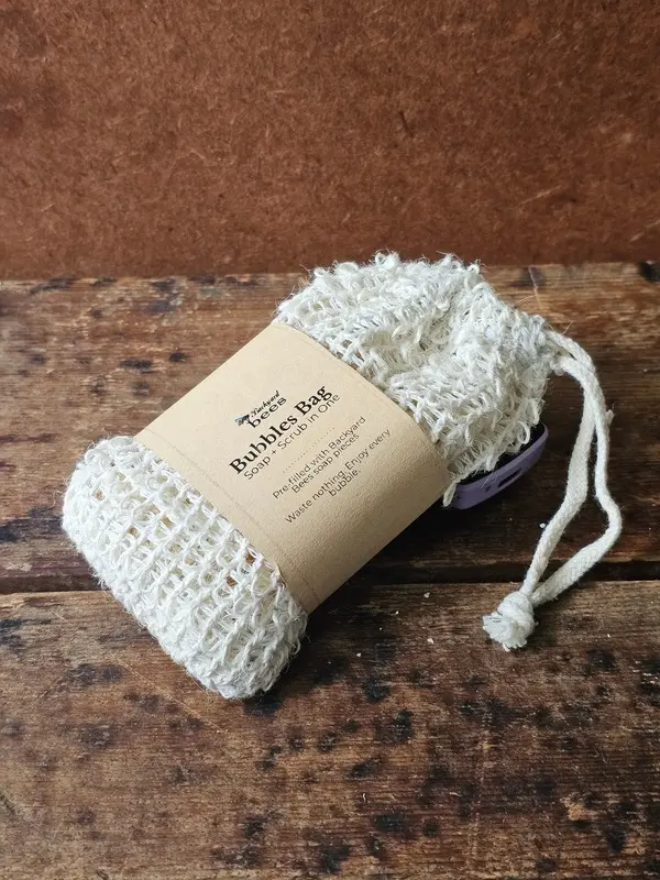 closeup of the Backyard Bees bubble bag, a reusable sisal soap saver bag prefilled with soap shreds
