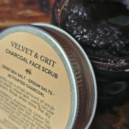 Open jar of charcoal face scrub showing rich exfoliating texture with activated charcoal and sea salts