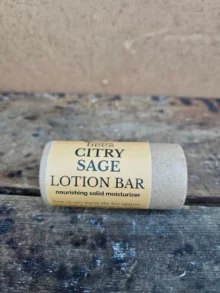 citry-sage-lotion-bar-hero Citry Sage Lotion Bar in compostable paper tube on rustic wood background