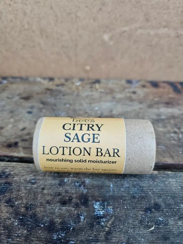 Citry-Sage-Lotion-Bar-Hero Citry Sage Lotion Bar in compostable paper tube on rustic wood background