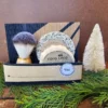 Coco Loco Holiday Coco Loco vegan shave gift set displayed with cedar greenery and seasonal bottle brush tree for holiday gift presentation.