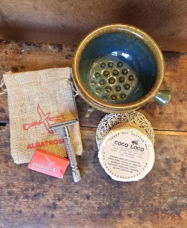 Coco-Loco-Razor-Option Stainless steel safety razor, shave brush, and Coco Loco shave bar on soap lift arranged on rustic wood grooming surface.