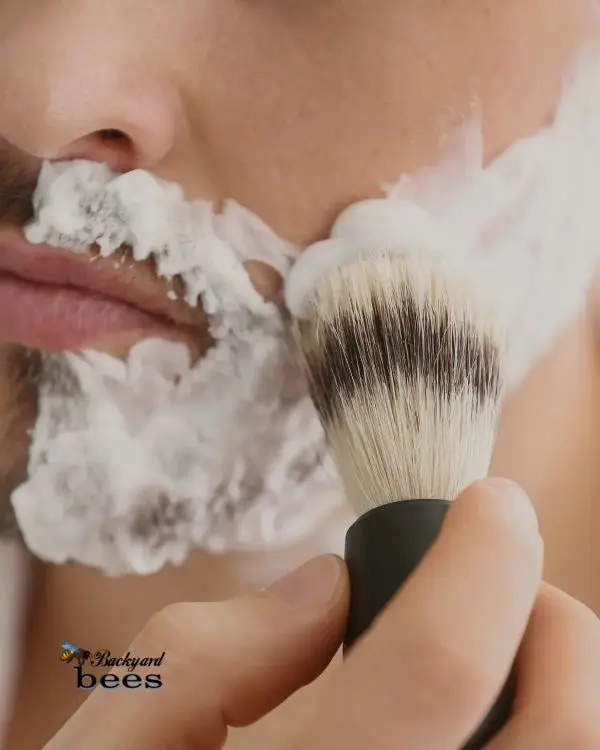 Coco-Loco-Shaving (1) Close-up of a man applying shaving lather with a shave brush, demonstrating the creamy foam from the Coco Loco vegan shave bar.