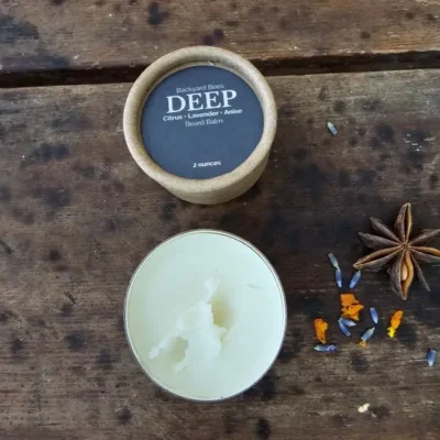 Open jar of DEEP beard balm showing the smooth beeswax-based balm inside.