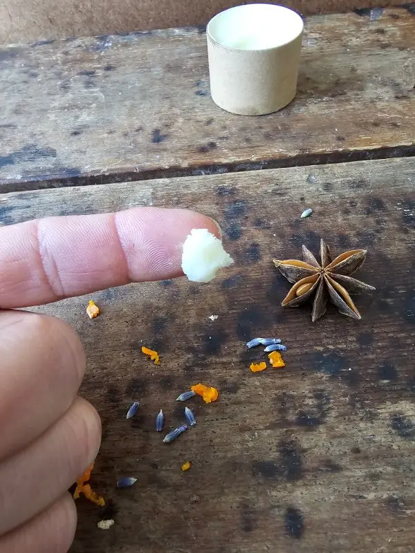 Texture of DEEP beard balm by Backyard Bees, showing a small amount of balm made with beeswax and botanical oils.