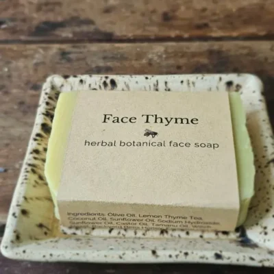 Face Thyme natural facial soap by Backyard Bees on a rustic table