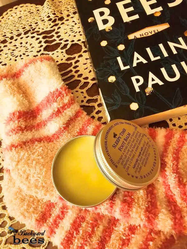 Foot Balm Bedside (2) Sleep Time Beeswax Overnight Foot Balm on bedside with cozy socks and a book