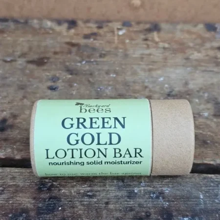 Green Gold Lotion Bar in compostable paper tube on neutral background