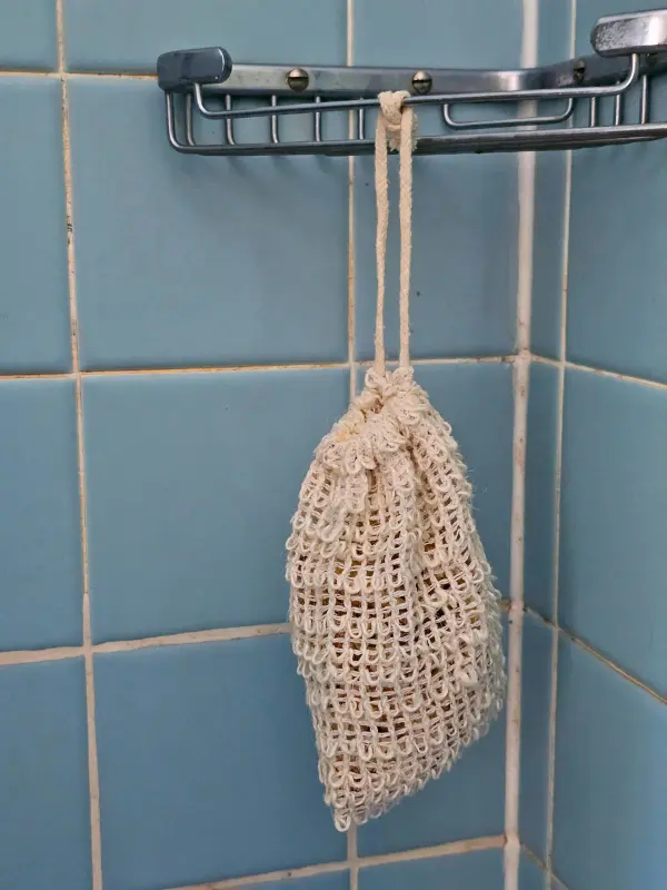 sisal soap saver bag hanging in shower