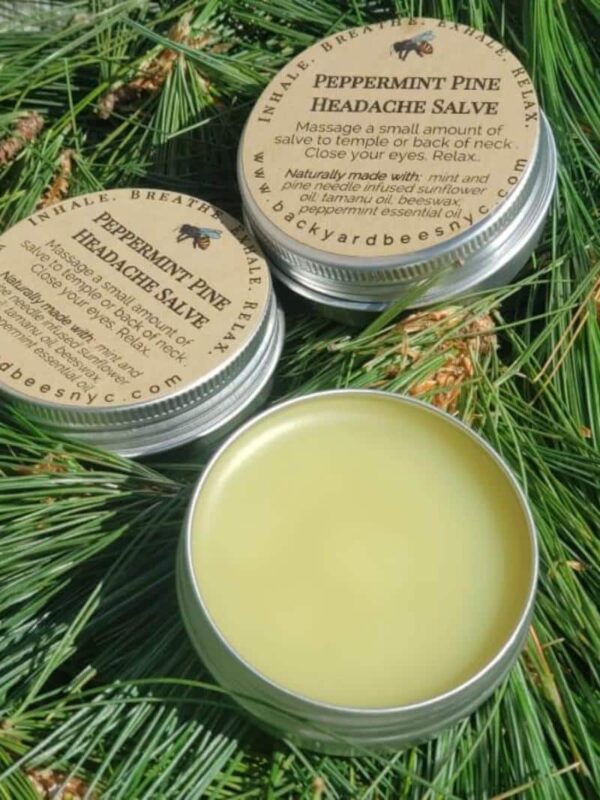 3 tins of peppermint Pine Headache Balm on a bed of fresh pine needles