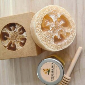 loofah foot soap outside of kraft cardboard box with small jar of honey