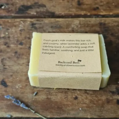 Back of Lavender Goat Milk soap label on rustic table with lavender sprig