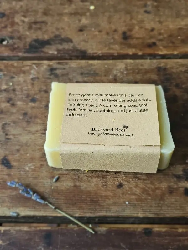 Back of Lavender Goat Milk soap label on rustic table with lavender sprig