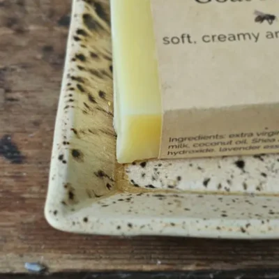 Close-up of Lavender Goat Milk Soap on rustic soap dish