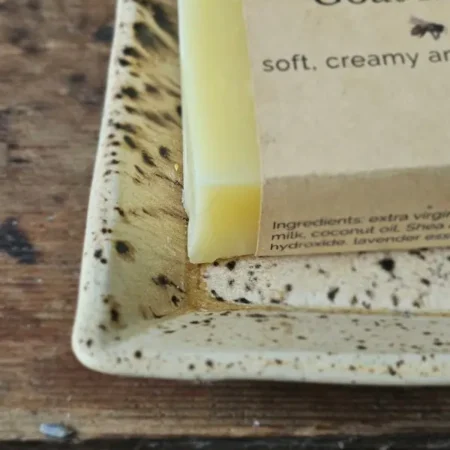 Close-up of Lavender Goat Milk Soap on rustic soap dish