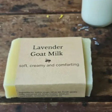 Lavender Goat Milk soap on rustic table with small jar of fresh goat milk