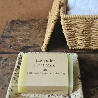 Lavender Goat Milk Soap by Backyard Bees on rustic soap dish with textiles