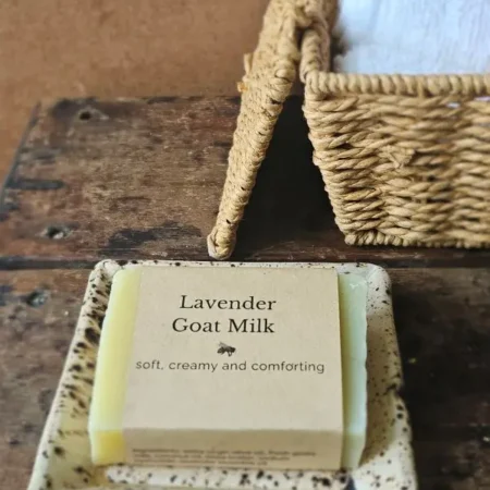 Lavender Goat Milk Soap by Backyard Bees on rustic soap dish with textiles