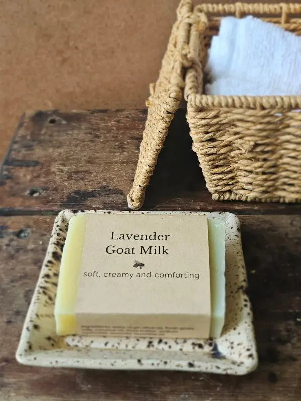 Lavender Goat Milk Soap by Backyard Bees on rustic soap dish with textiles