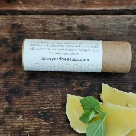 Back label showing the ingredients and compostable paper tube for Lemon Bomb lip balm