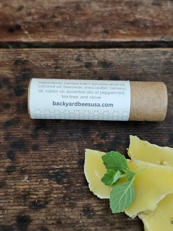 Back label showing the ingredients and compostable paper tube for Lemon Bomb lip balm