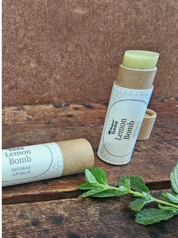 Lemon Bomb beeswax lip balm with cooling peppermint, tea tree, and clove essential oils