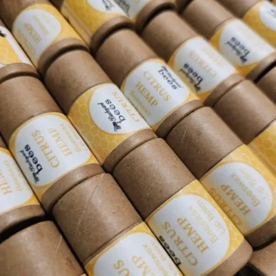 Lip Balm Citrus Close rows of Citrus Hemp Beeswax Lip Balms in paper tubes