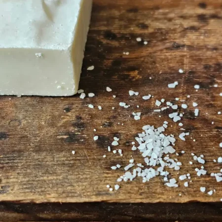 closeup of sea salt next to The Mariner soap for sensitive skin