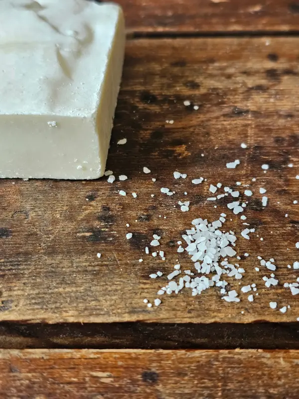 closeup of sea salt next to The Mariner soap for sensitive skin