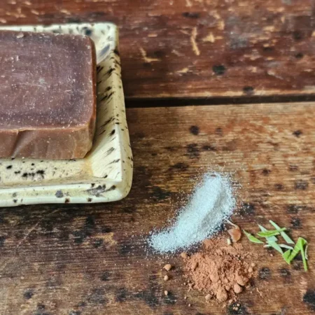 closeup of ground pumice, cocoa powder and mint leaves featured in Peppermint Pumice soap