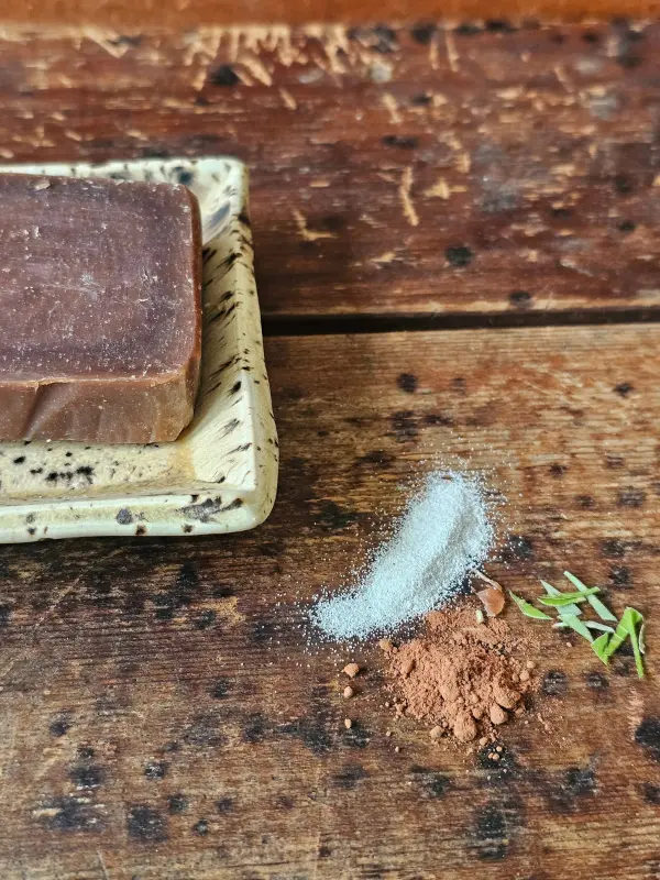 closeup of ground pumice, cocoa powder and mint leaves featured in Peppermint Pumice soap