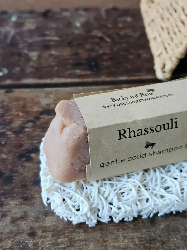 Close up of Rhassouli shampoo bar on white soap lift