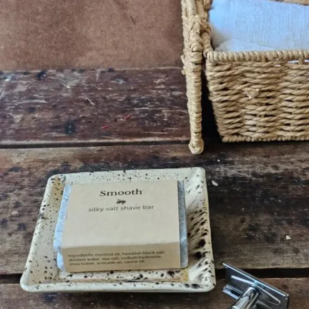 Styled SMOOTH ladies shave soap with safety razor and bath towels in rustic setting