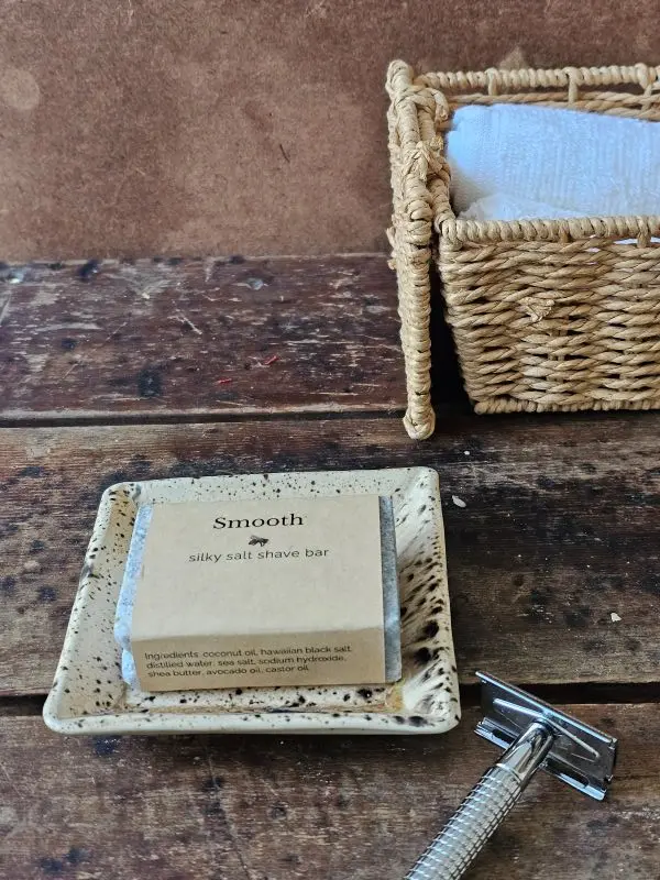 Styled SMOOTH ladies shave soap with safety razor and bath towels in rustic setting
