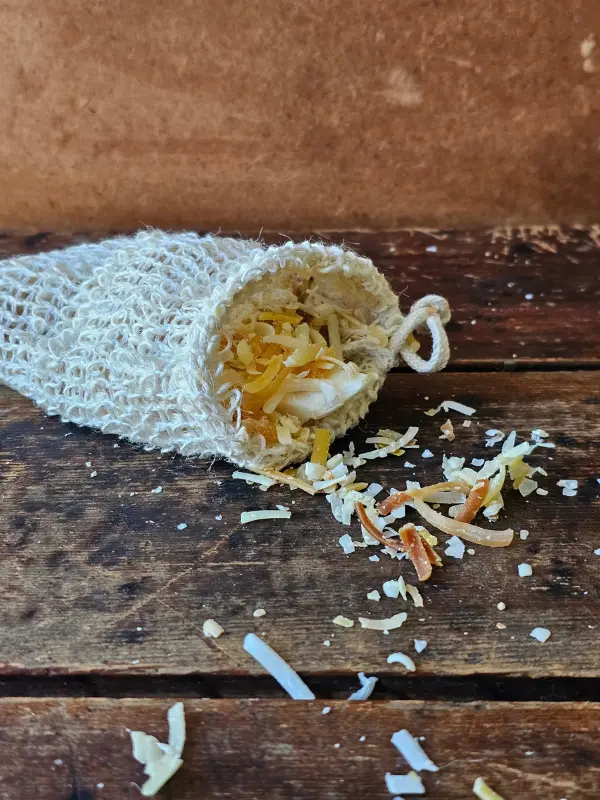 shredded soap pieces spilling out of soap saver bag on wood table