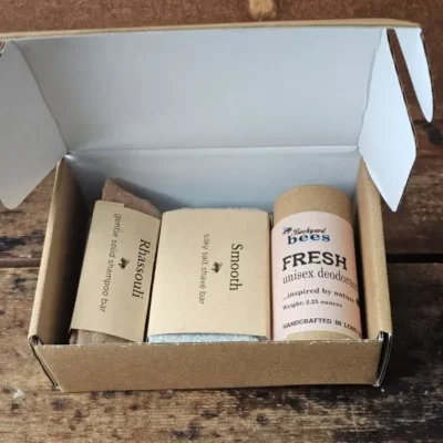 Plastic-free daily care set with shampoo bar, shave bar, and aluminum-free deodorant in kraft box