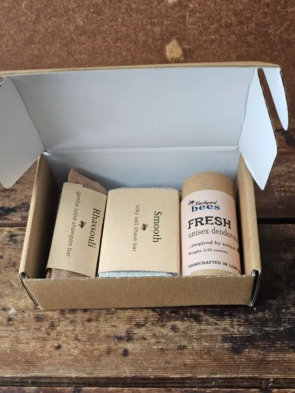 Plastic-free daily care set with shampoo bar, shave bar, and aluminum-free deodorant in kraft box
