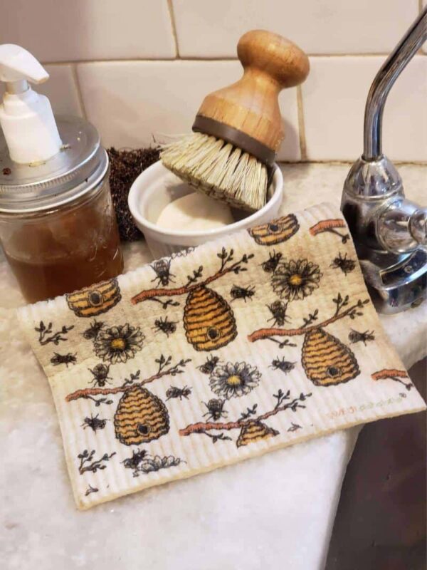 bee-themed swedish dishcloths next to sink