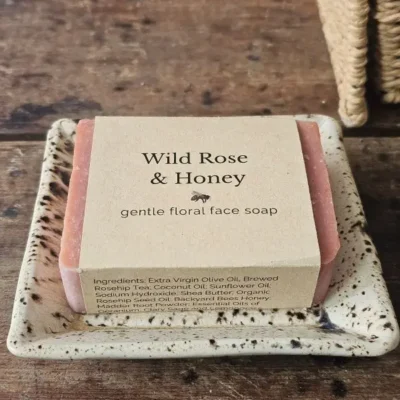 Wild Rose and Honey gentle floral face soap on ceramic dish
